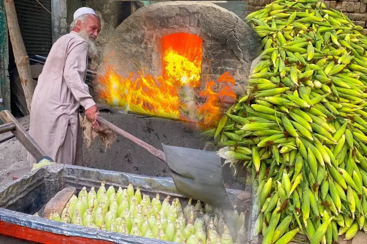 (ویدئو) ببینید این پیرمرد 70 ساله پاکستانی چگونه ذرت ها را برای فروش در شن داغ می پزد